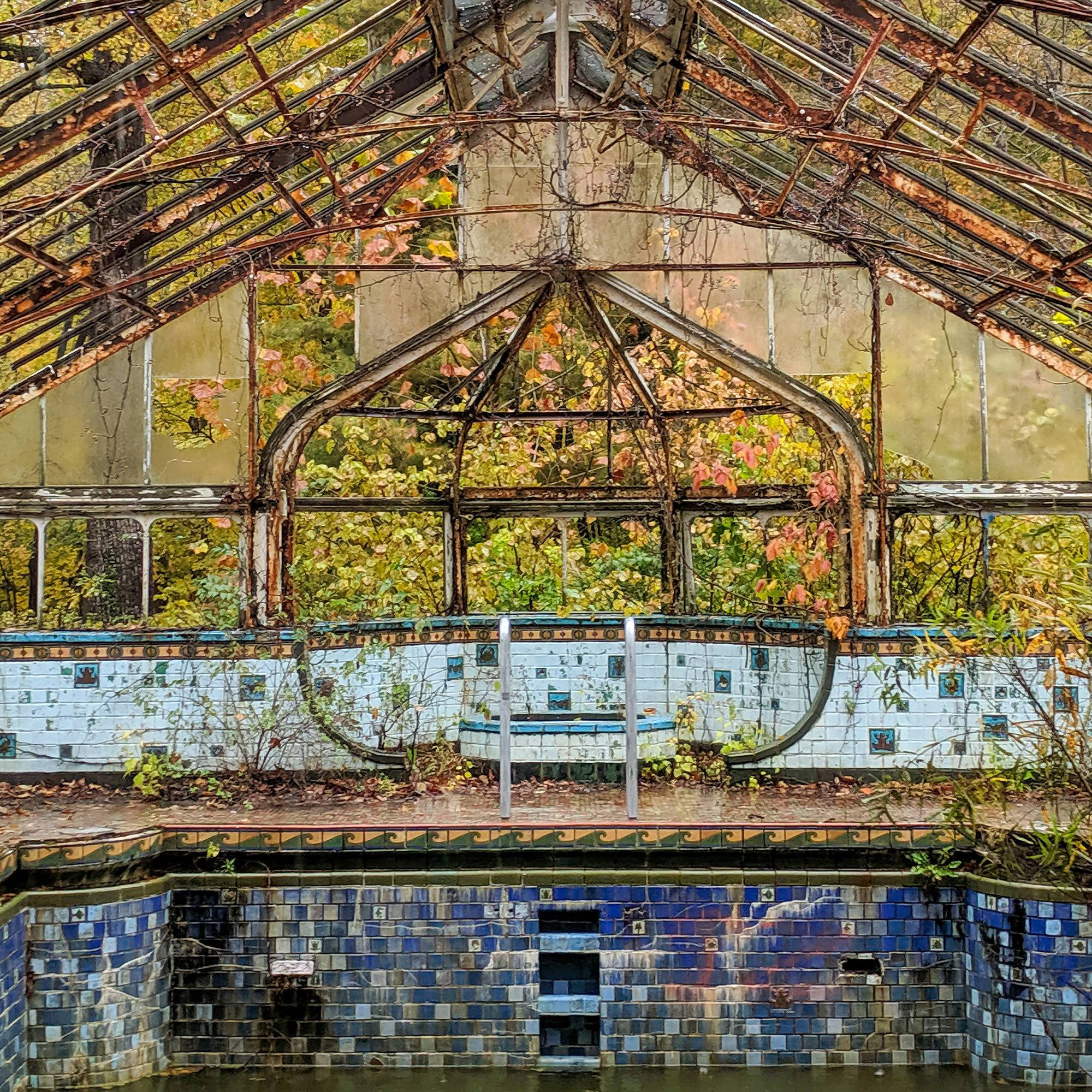 Photograph of the interior of a worn down building with tiling.